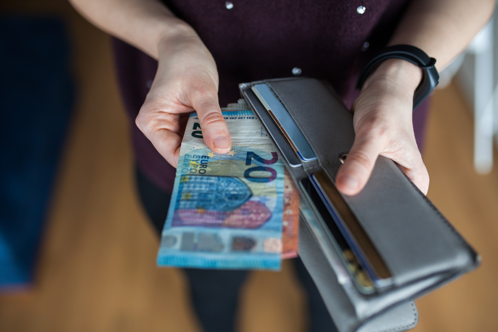 Woman taking out money from wallet